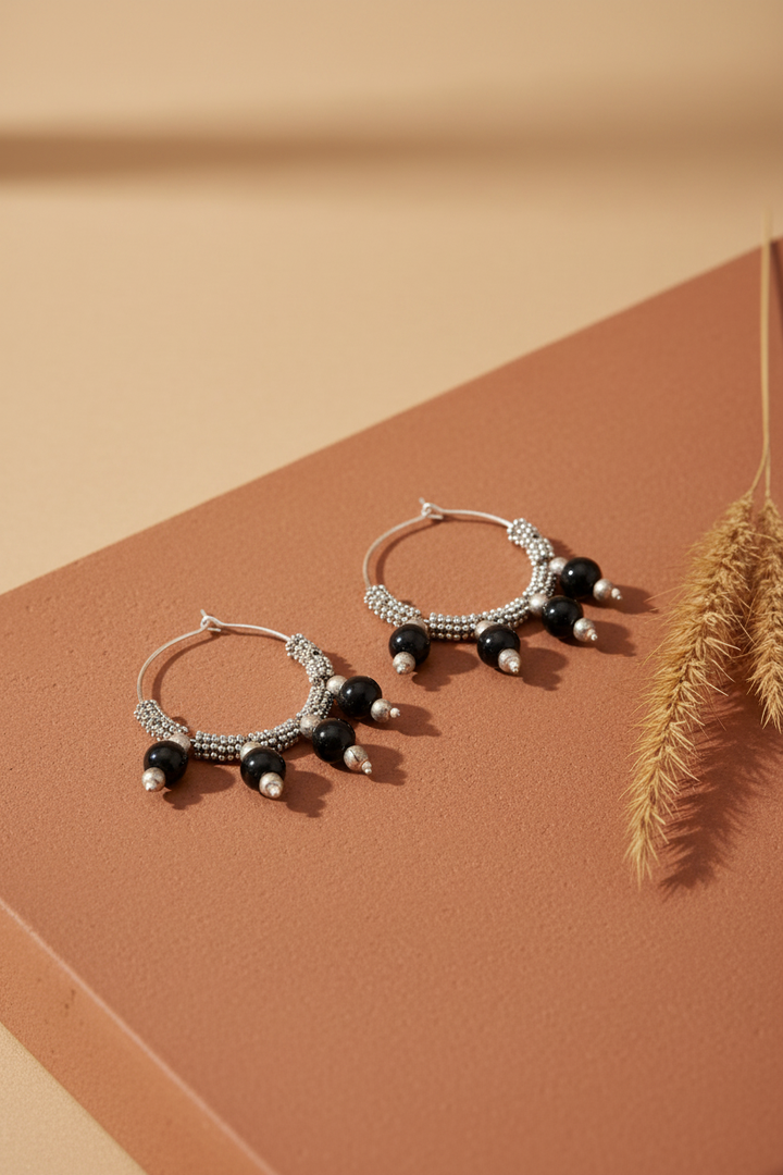 Black Onyx Ghungroo Balli - lifestyle shot on warm earthy terracotta background